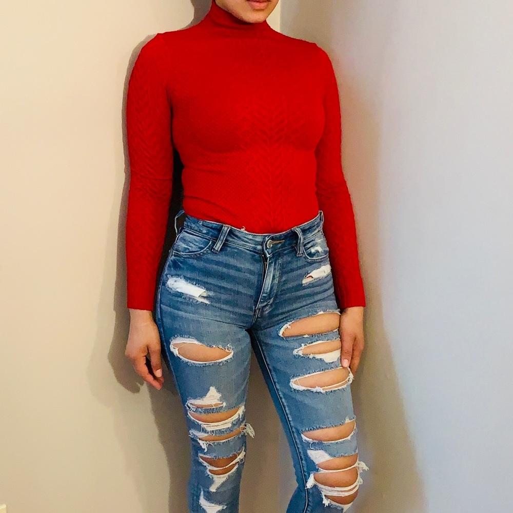Red turtleneck long sleeve sweater.
